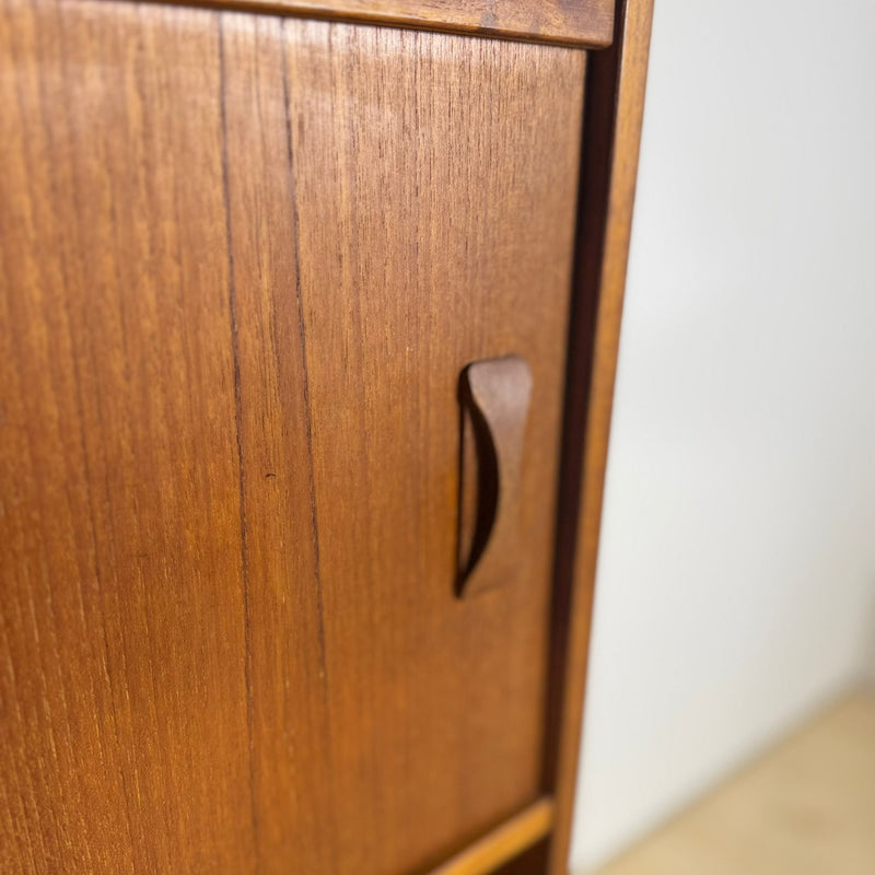 Ante scorrevoli in teak con maniglie integrate, dettaglio venature.